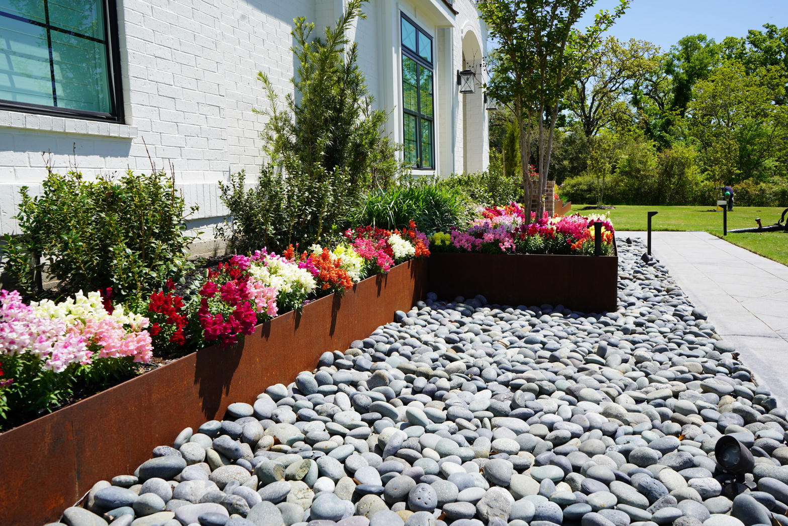 Seasonal color beds with river rock
